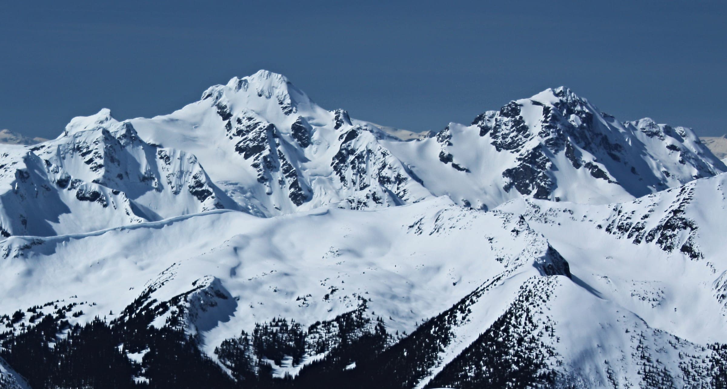 Mount Matier and Joffre Peak stand under deep snow in a view from Silent Hub above Cerise Creek.