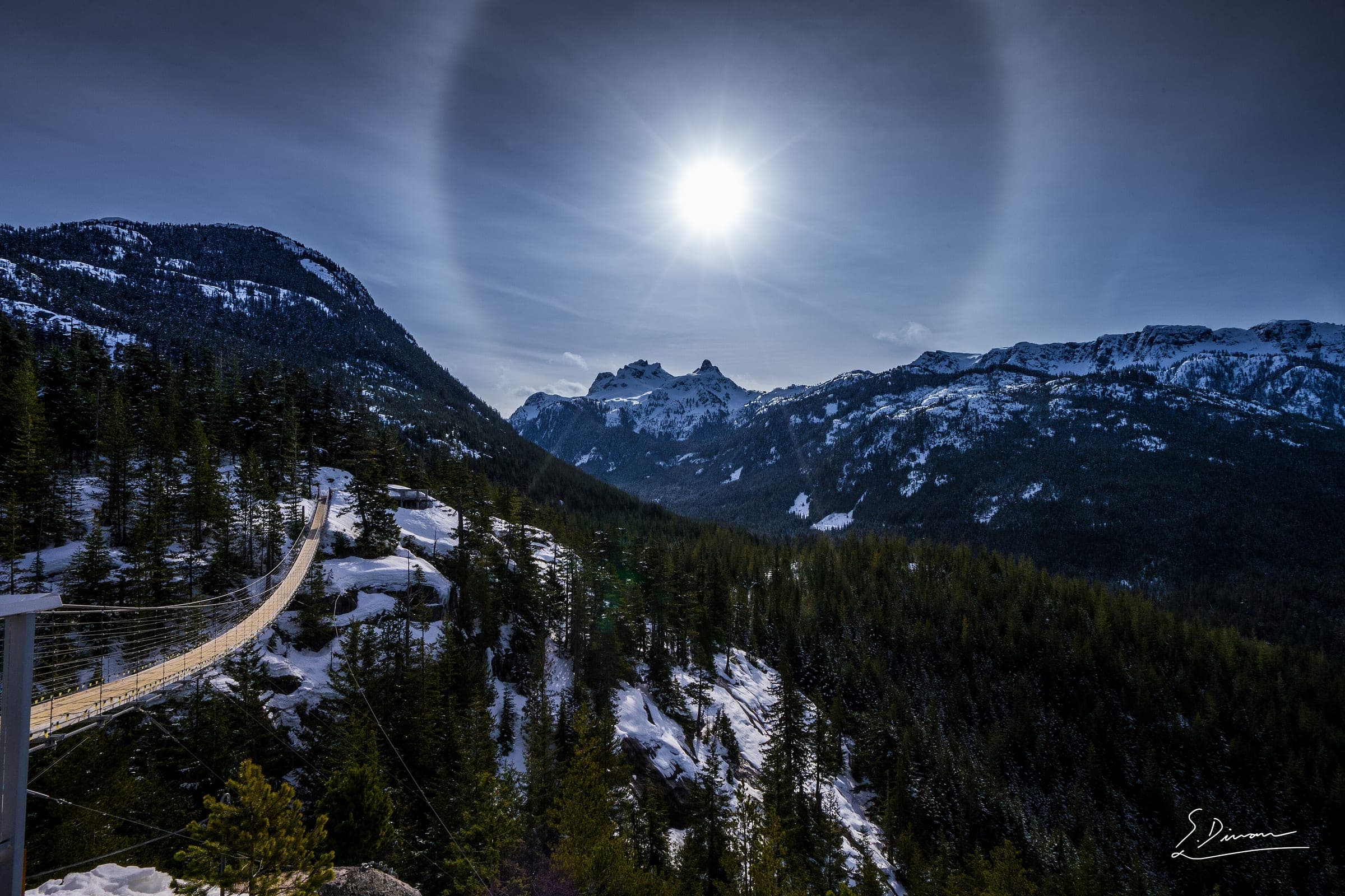 A sun halo hangs over the Sea to Sky Gondola summit and its suspension bridge above Squamish.
