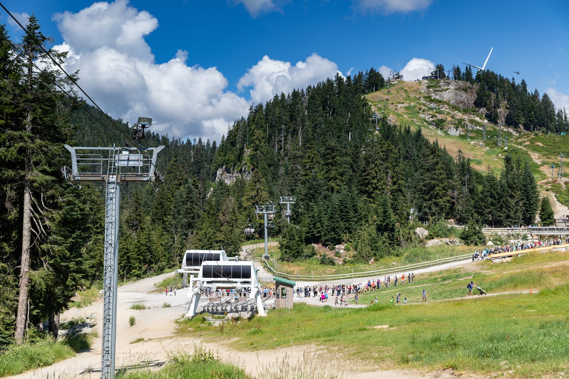A chairlift climbs the grassy summer slopes of Grouse Mountain above North Vancouver.
