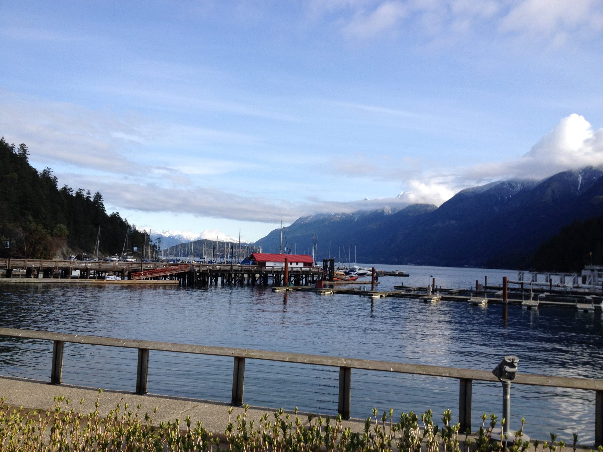 Cloud lifts off the peaks above the Horseshoe Bay marina and pier at the end of Marine Drive.