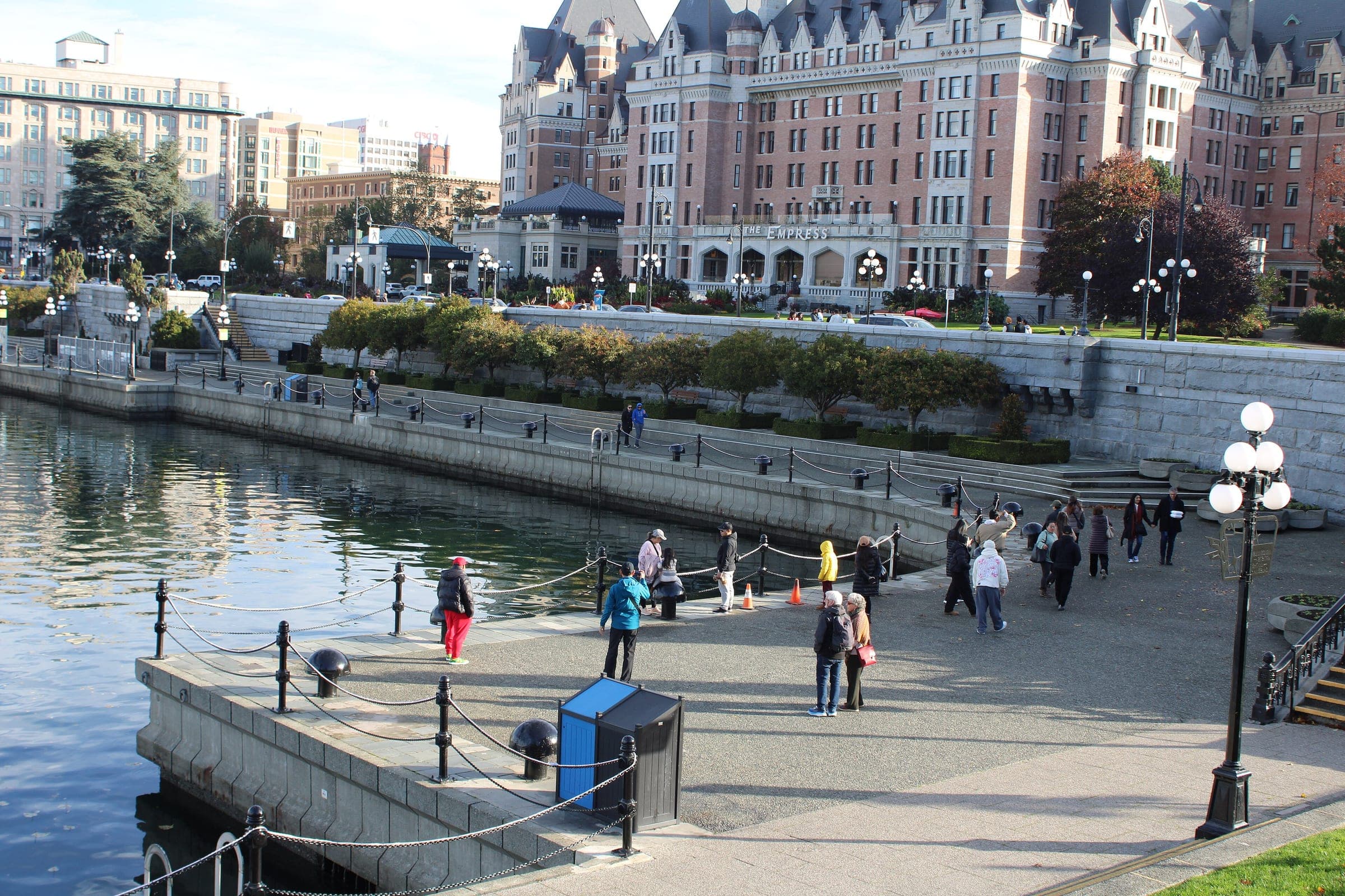 Walkers follow the Inner Harbour Causeway in Victoria below the Fairmont Empress.