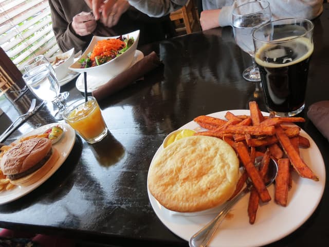 A pot pie with sweet potato fries and a dark ale on a table at the Howe Sound Brewing pub in Squamish.