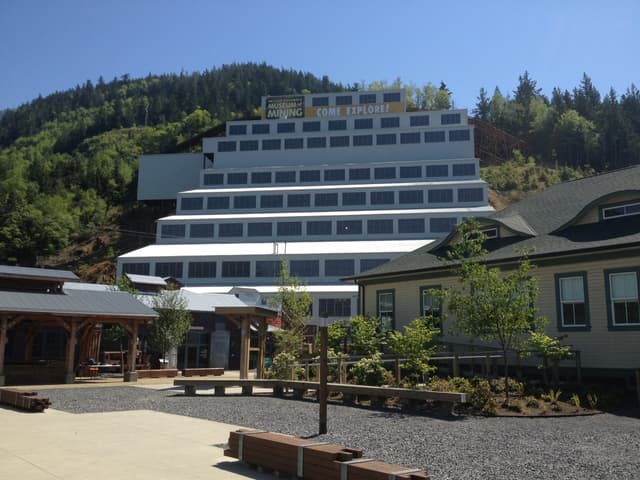 The stepped concentrator building rises behind the courtyard at the Britannia Mine Museum
