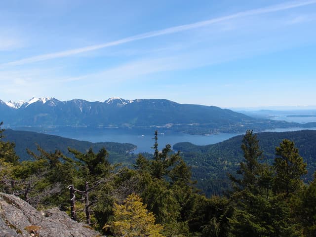 Snowy North Shore peaks rise beyond Howe Sound in the view from Mount Gardner's north summit on Bowen Island.