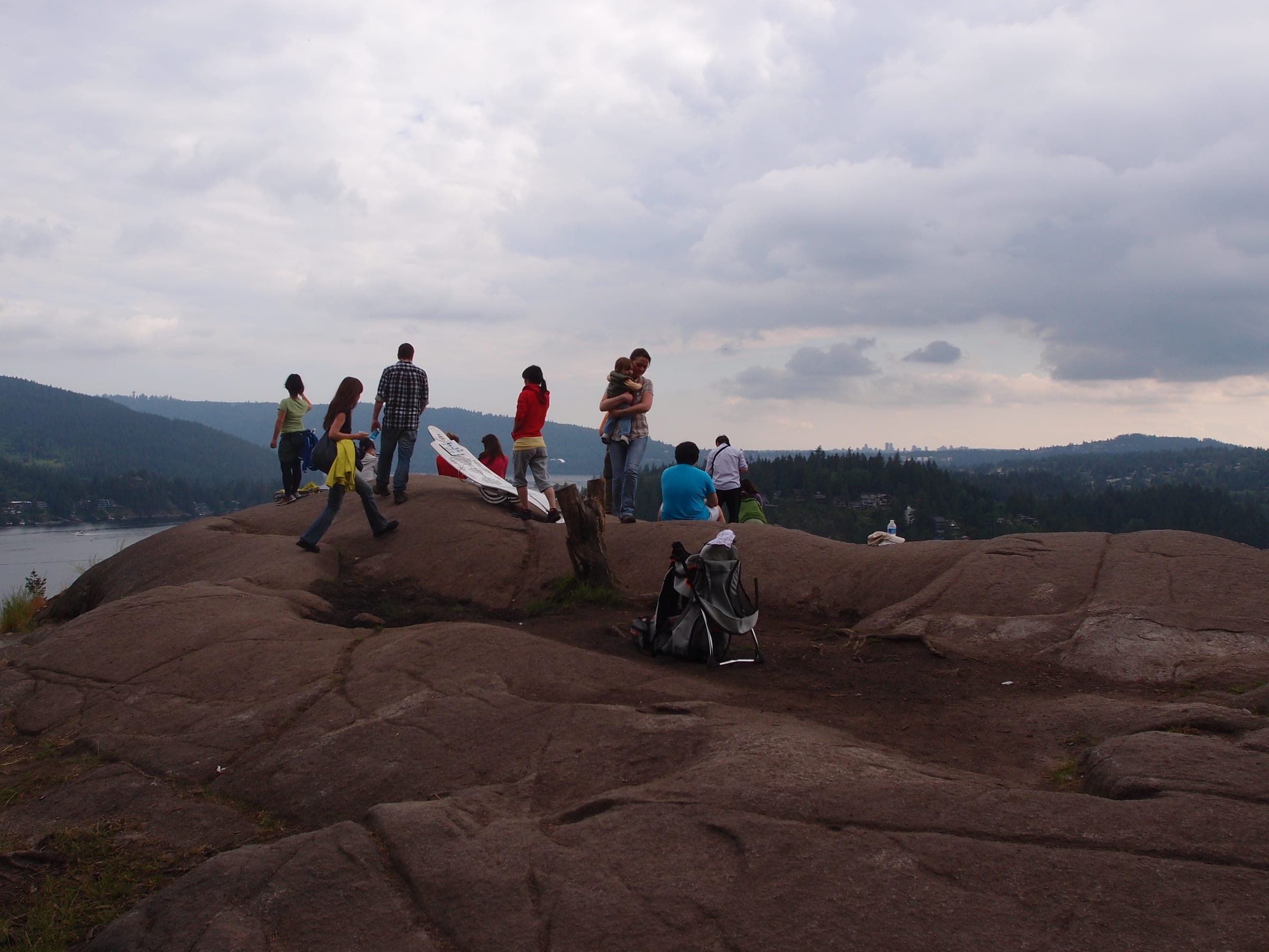 Hikers gather on the bare granite top of Quarry Rock on the Baden-Powell Trail above Deep Cove.