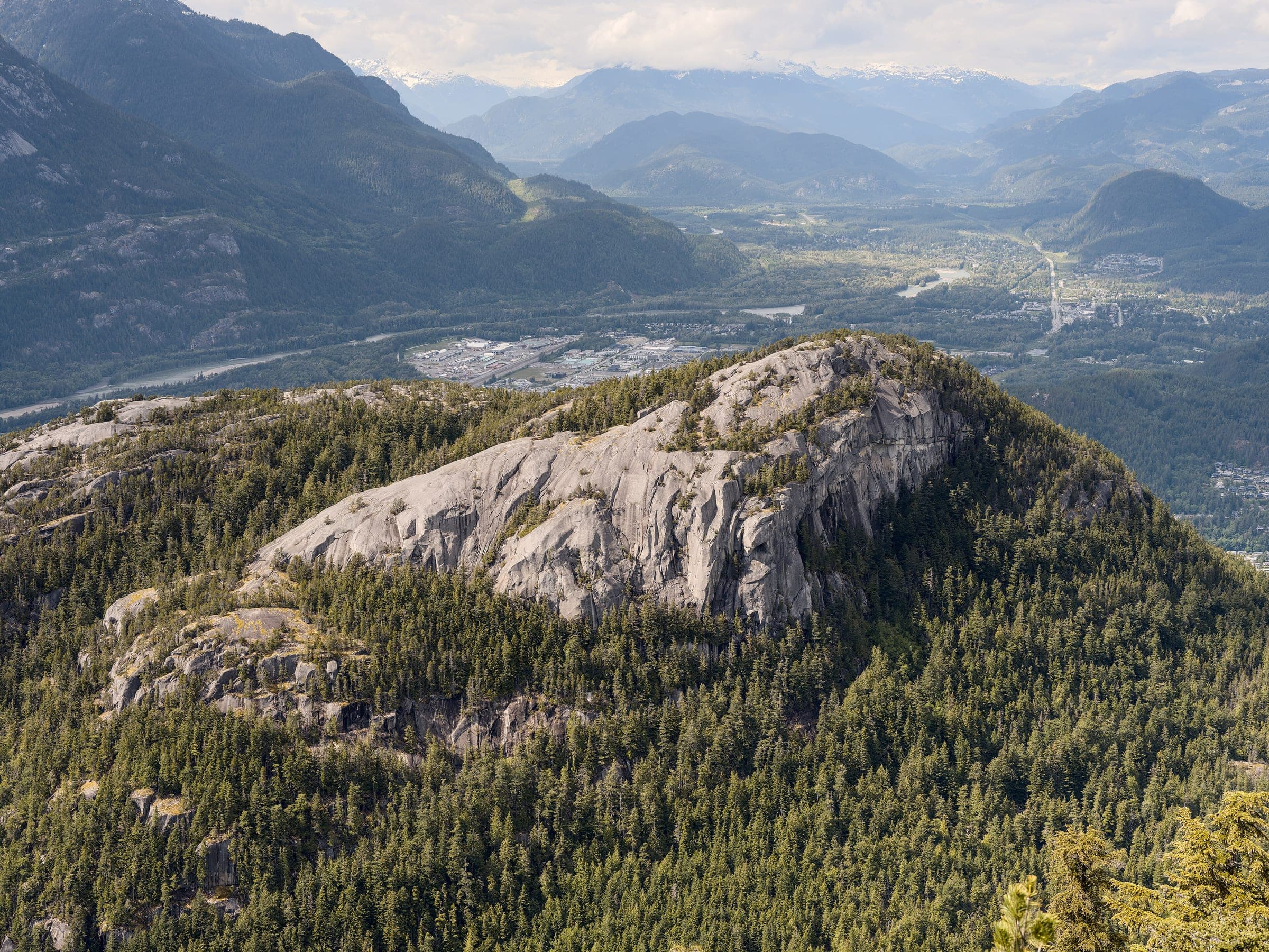 The Stawamus Chief's granite dome rises from forest in the view from the Chief Overlook at the gondola summit.