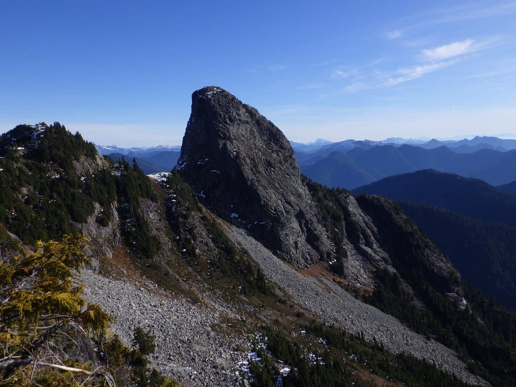 The granite tower of the East Lion rises above scree in the view from the West Lion on the North Shore.