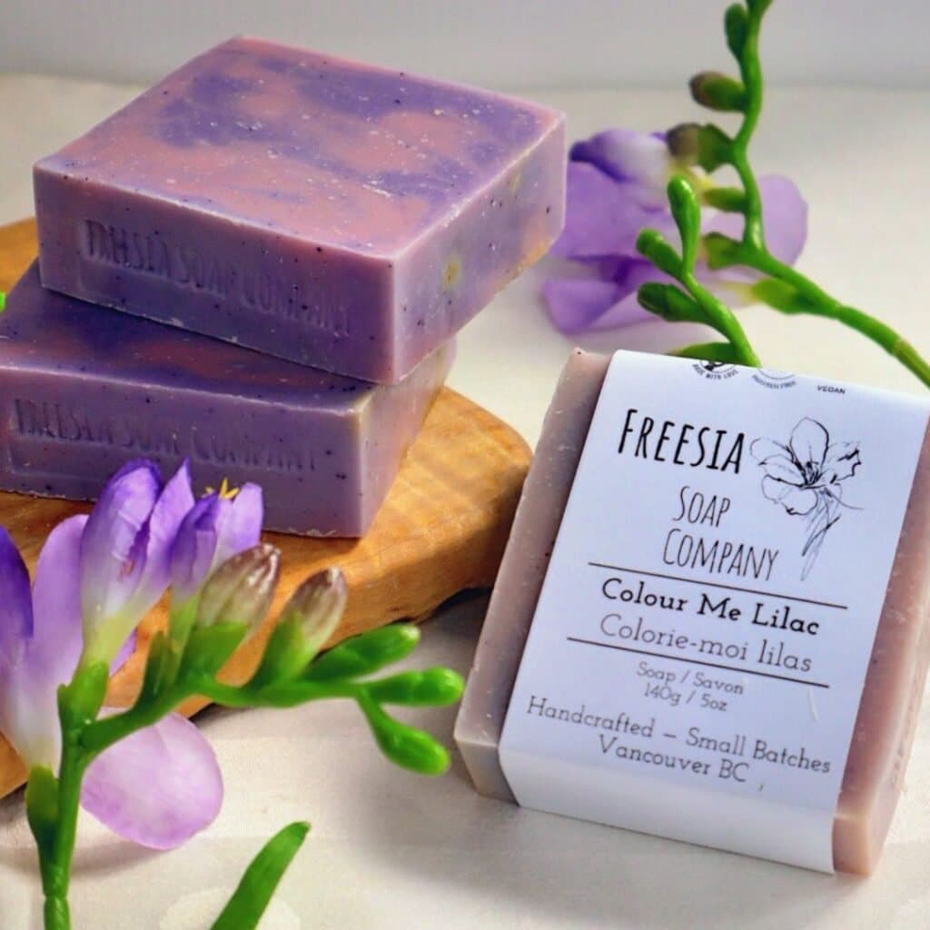 Bars of Freesia Soap Company's Colour Me Lilac soap with sprigs of purple freesia.