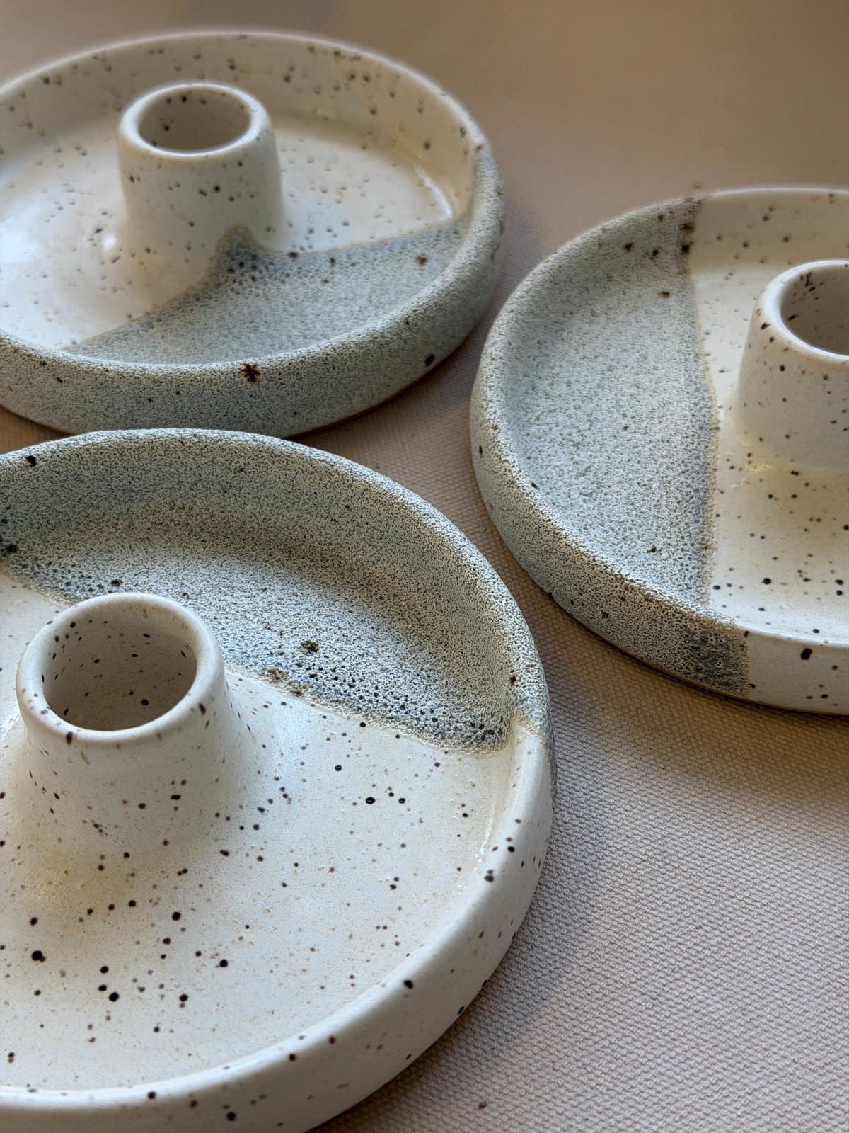 Speckled JAM Pottery candle holders seen from above.