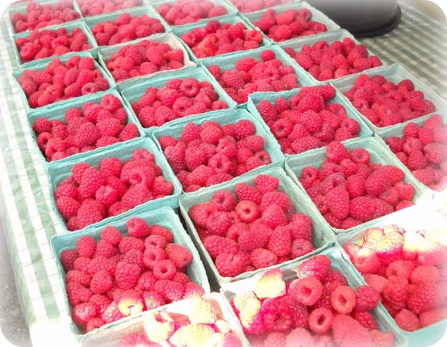 Baskets of raspberries on a stall at the West End Farmers Market