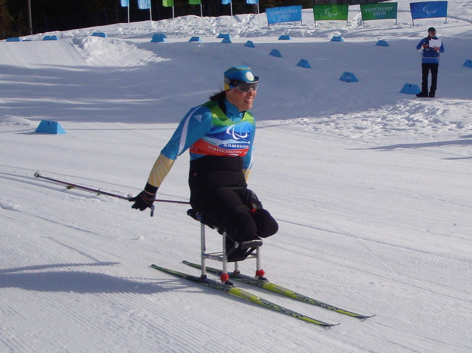 A sit-skier races across groomed snow at Whistler Olympic Park during the 2010 Winter Paralympics.