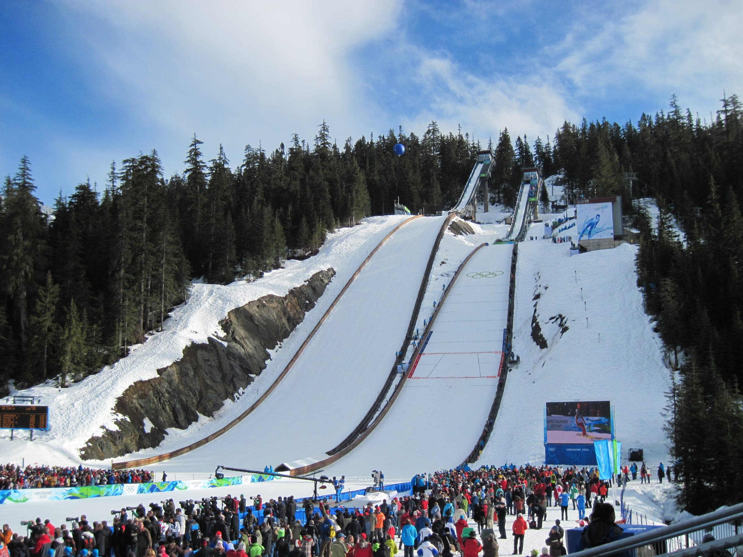Crowds fill the outrun below the two ski jumps at Whistler Olympic Park during the 2010 Winter Games.