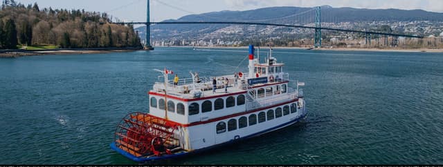 The Harbour Cruises paddlewheeler runs under Lions Gate Bridge on Burrard Inlet.