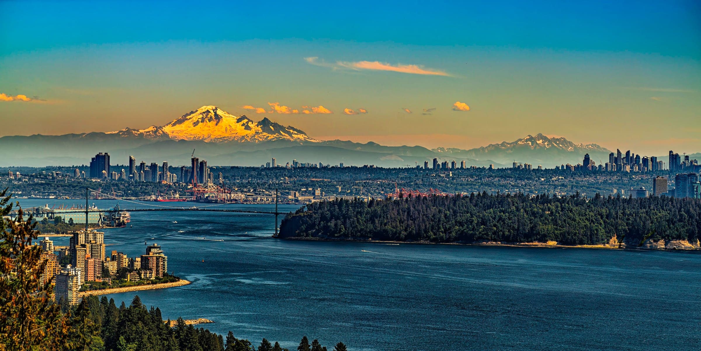 Mount Baker glows at sunset above downtown Vancouver, Stanley Park and the Lions Gate Bridge from the Cypress lookout.