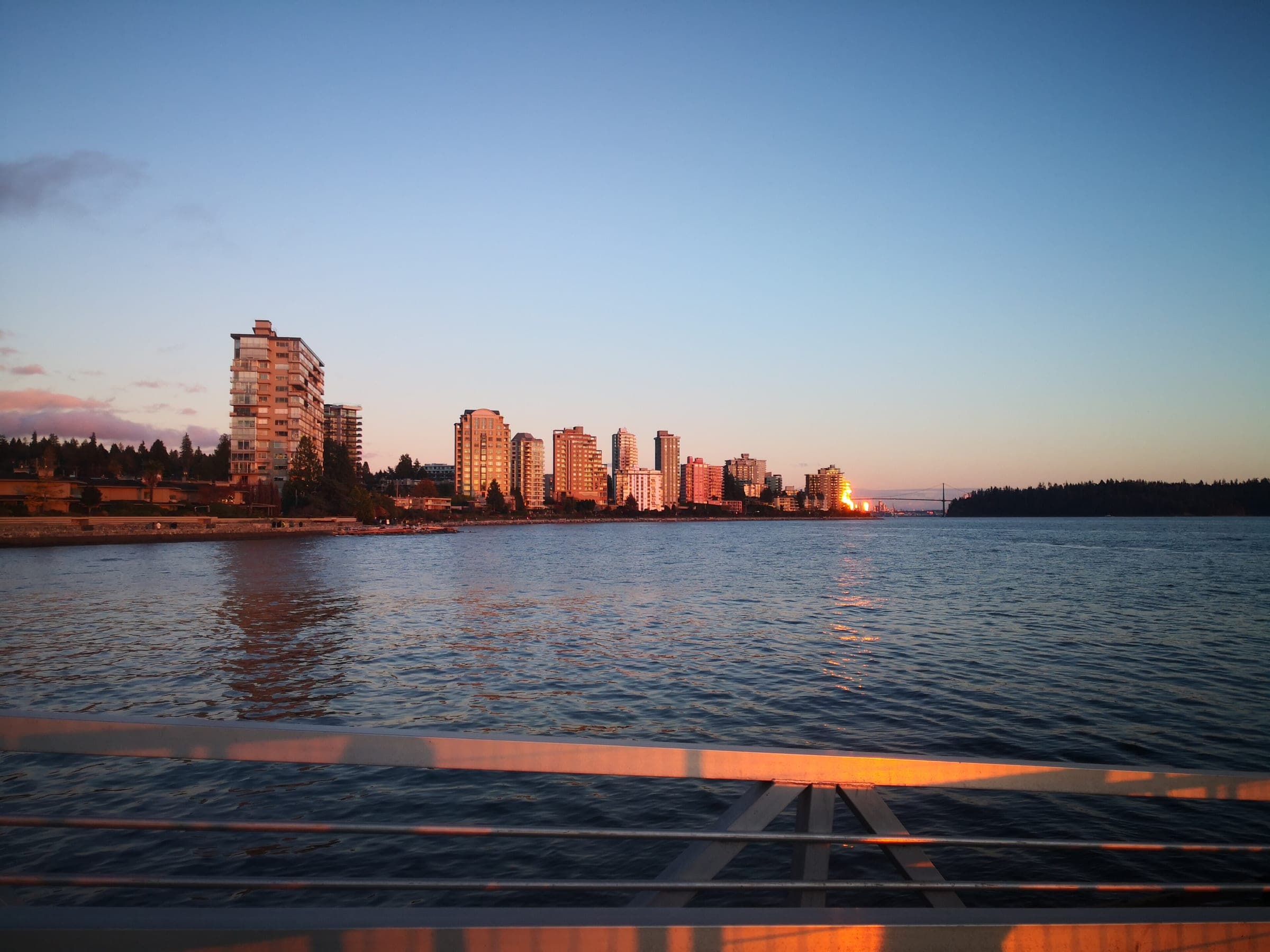 Sunset turns the waterfront towers of West Vancouver gold along the shore of Burrard Inlet in November.