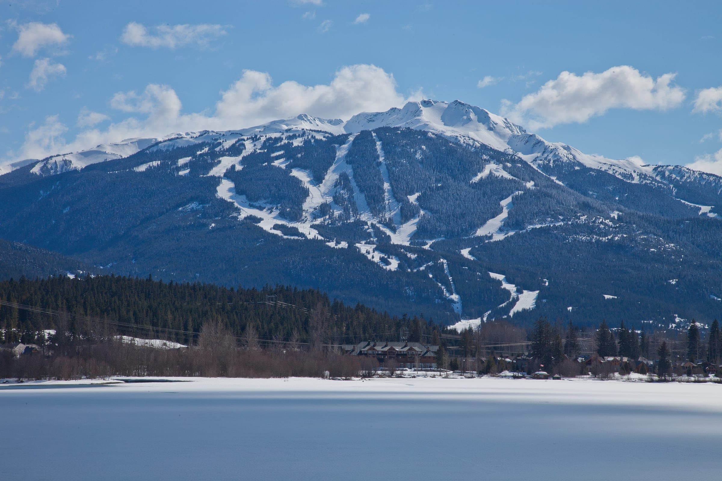 Snow lies on frozen Green Lake below the ski runs of Whistler Mountain in early April.