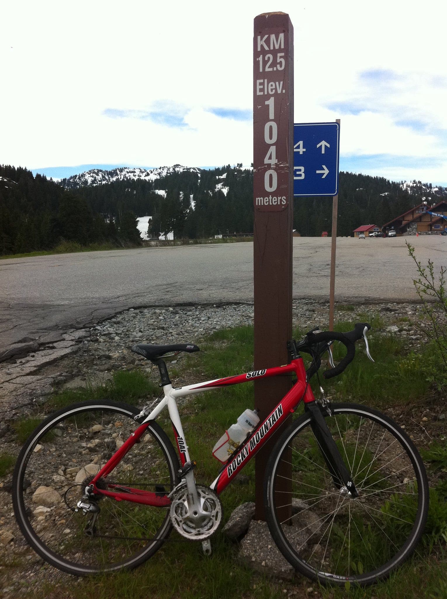 A road bike leans on the 12.5 km marker at 1,040 metres where Mount Seymour Road ends below the ski area.