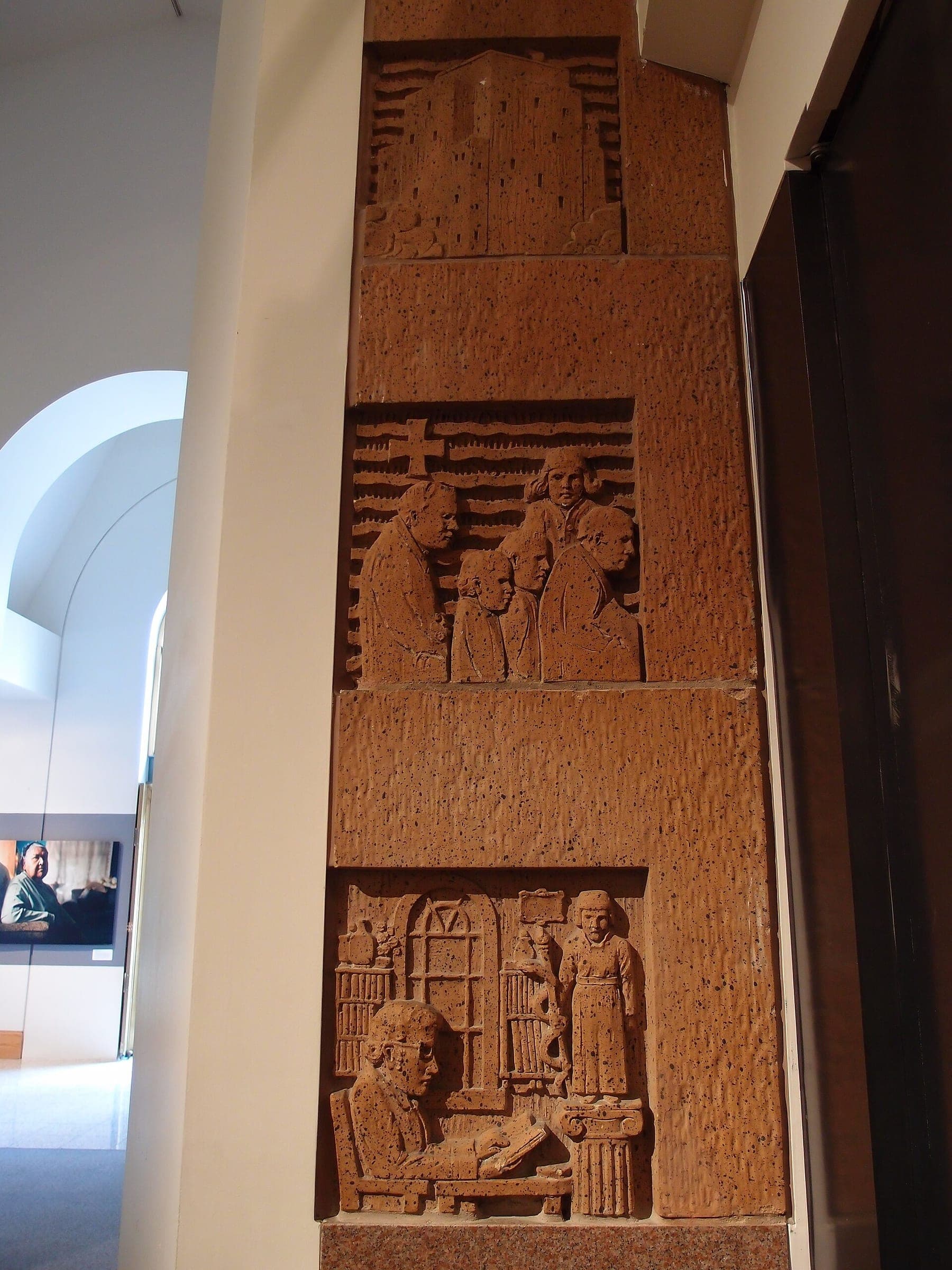 Carved relief panel beside the entrance of the Bill Reid Gallery in downtown Vancouver.