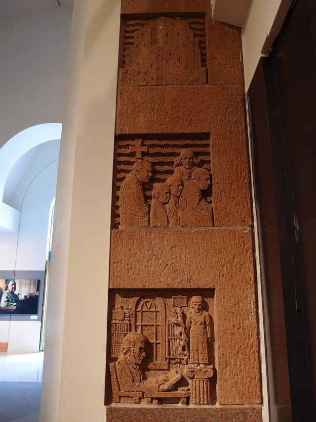 Carved relief panel beside the entrance of the Bill Reid Gallery in downtown Vancouver.