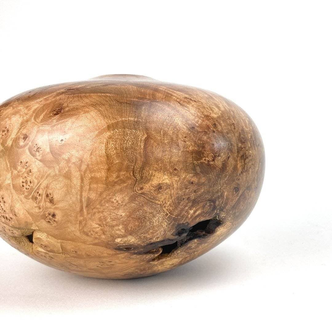 Smooth burl wood vessel on a white background, a handmade piece from the Craft Council of BC.