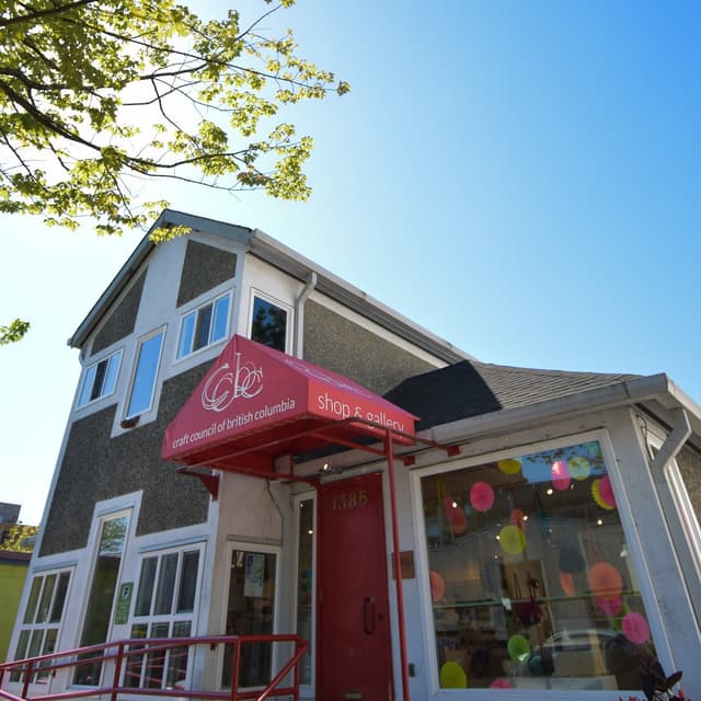The Craft Council of BC shop on Granville Island with a red awning and a colourful window display.