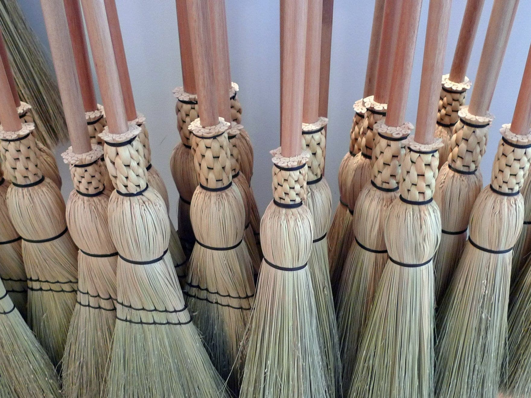 Rows of hand-stitched broomcorn brooms stand on display at Granville Island Broom Company in Vancouver.