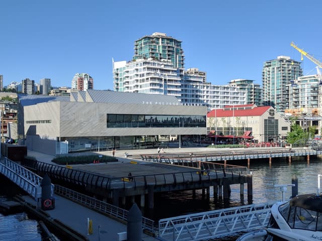 The Polygon Gallery on the North Vancouver waterfront seen from the Shipyards with moored boats in front.