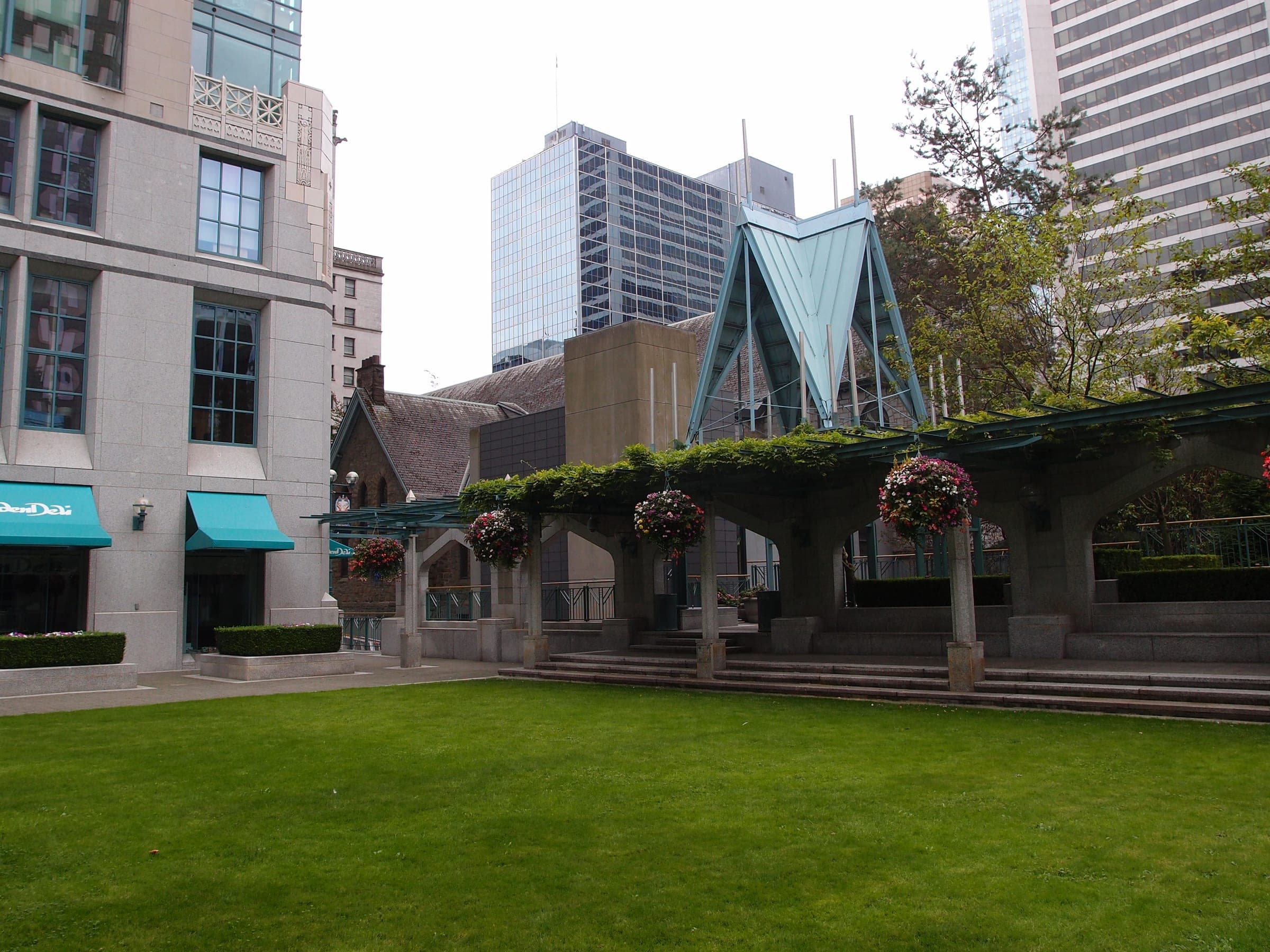 A lawn and vine-covered arcade fill the Cathedral Place courtyard beside the Bill Reid Gallery downtown.