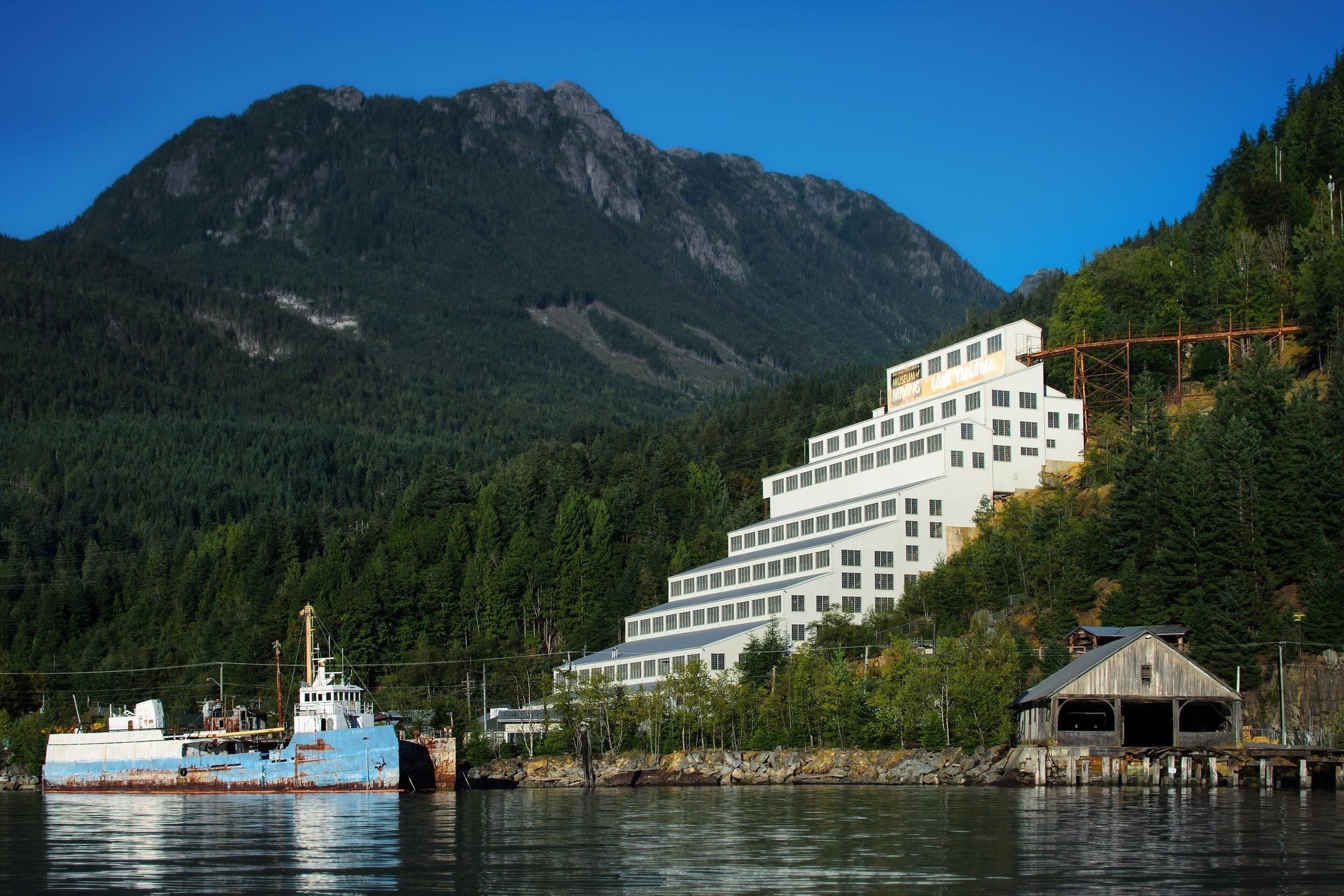 The white terraced concentrator of the Britannia Mine Museum climbs the hillside above Howe Sound.