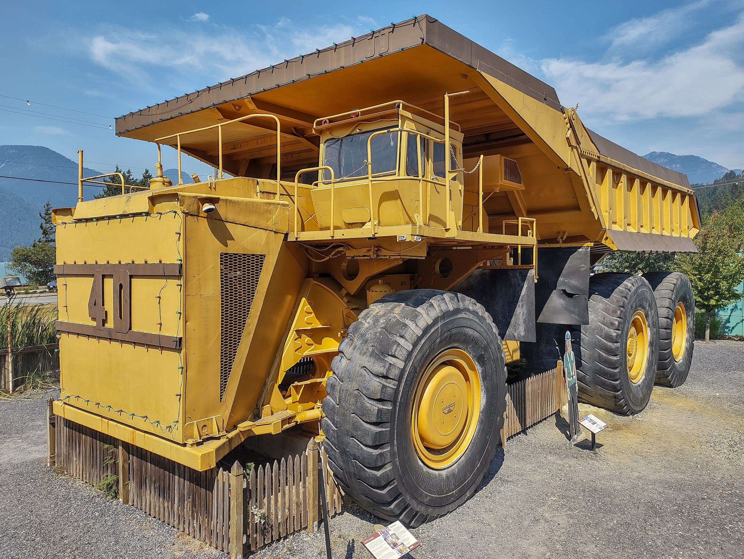 A giant yellow haul truck sits on display in the yard of the Britannia Mine Museum.