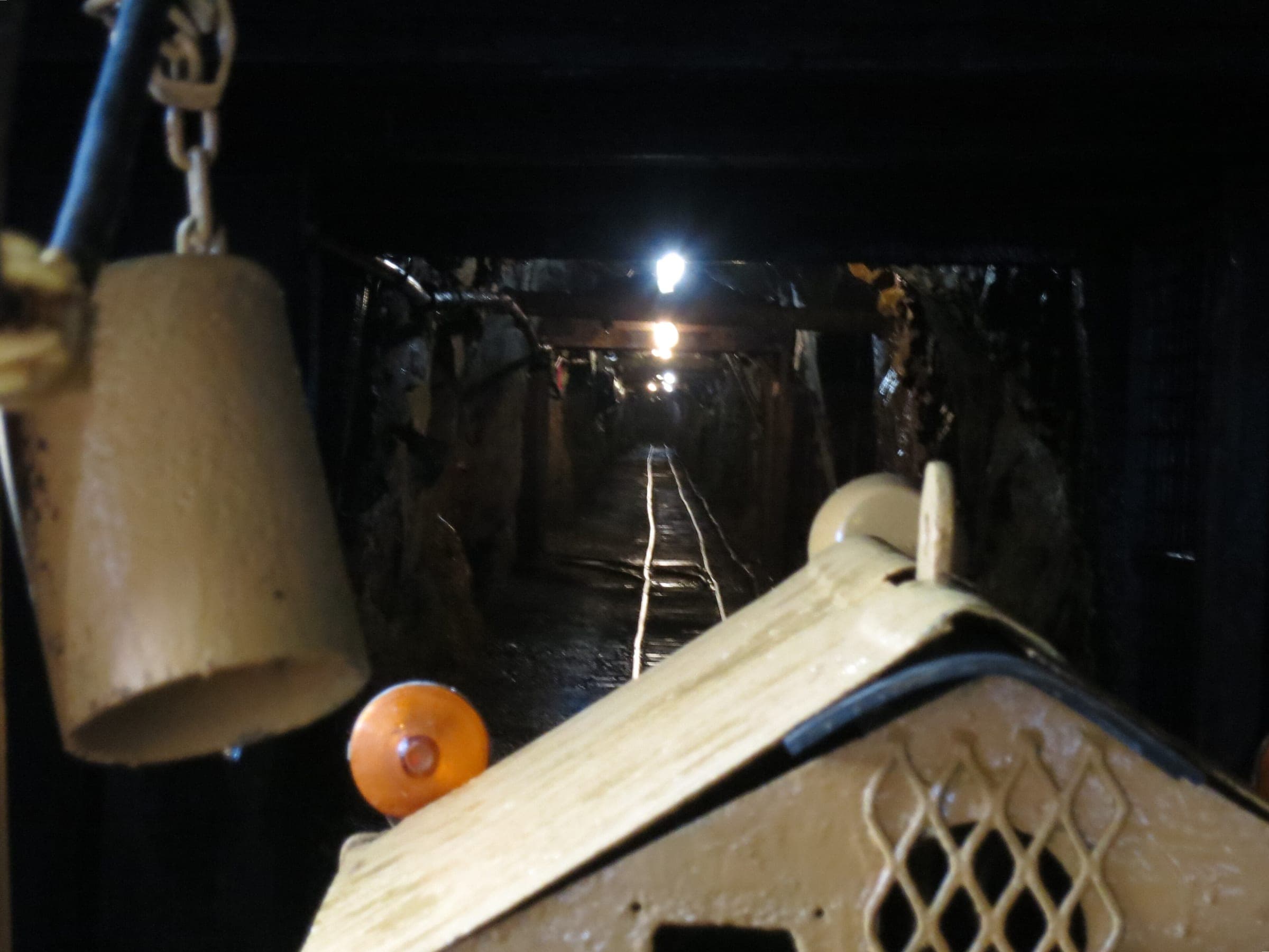 The mine train's bell hangs over a lamp-lit tunnel on the underground tour at the Britannia Mine Museum.