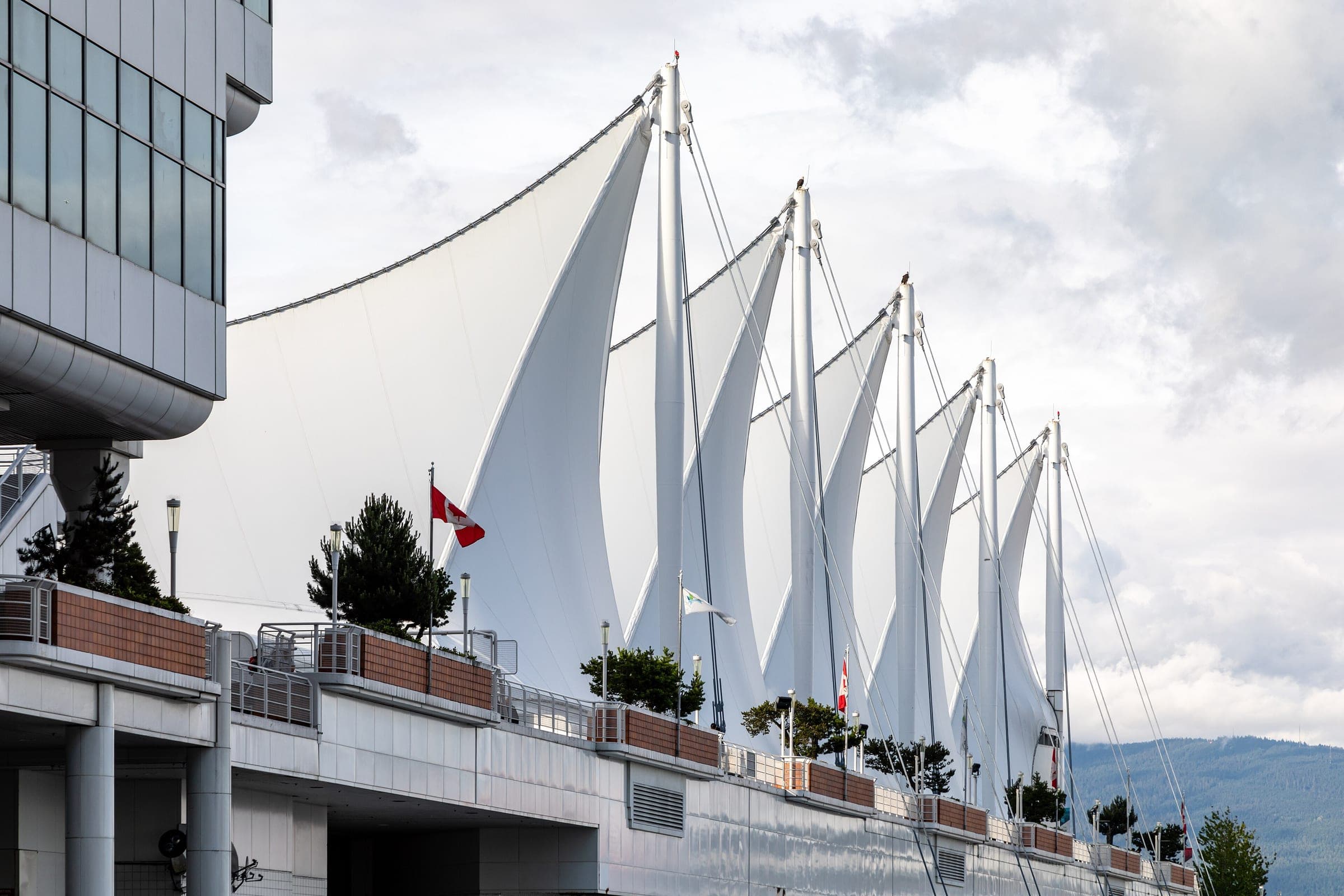 Fabric sails and Canadian flags line the promenade deck of Canada Place in Vancouver.