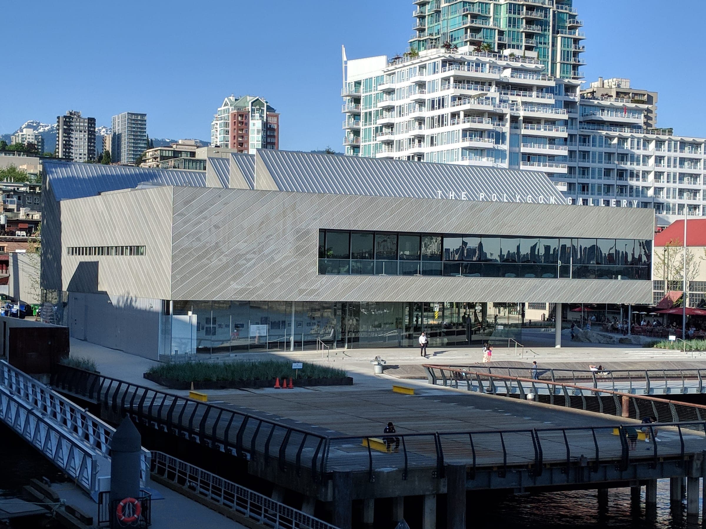 The Polygon Gallery's mirrored facade faces the plaza and pier at the foot of Lonsdale.
