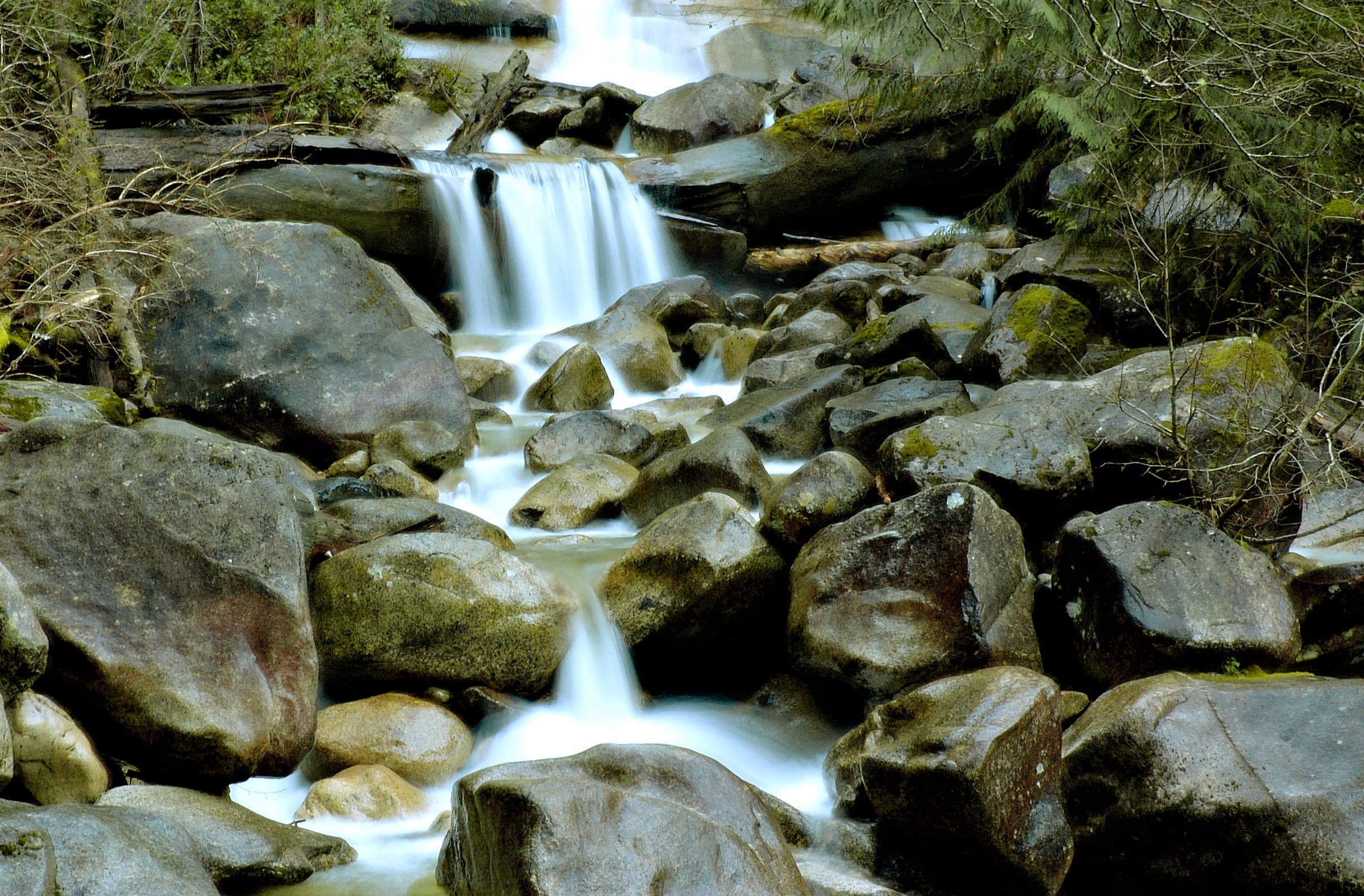 Shannon Creek spills over mossy boulders below the falls in Shannon Falls Provincial Park.