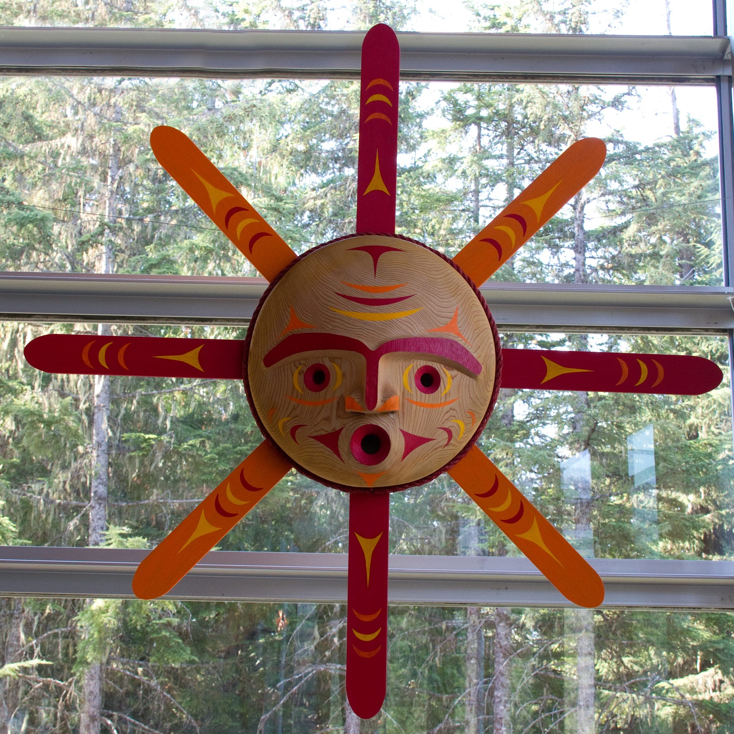 A carved and painted sun design hangs in the Squamish Lil'wat Cultural Centre in Whistler.