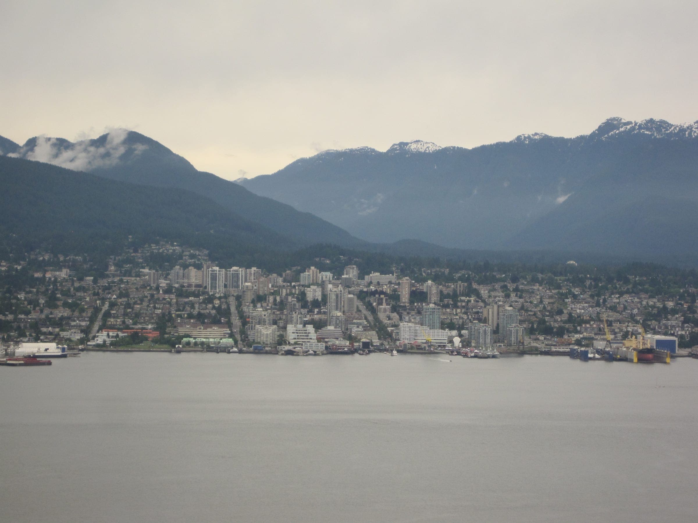 North Vancouver and the snow-streaked North Shore mountains rise across Burrard Inlet from the Vancouver Lookout.