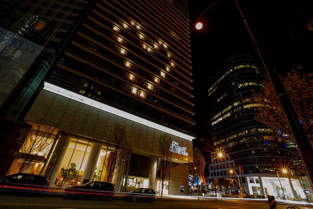 Fairmont Pacific Rim at night with windows lit in a heart shape above the entrance.