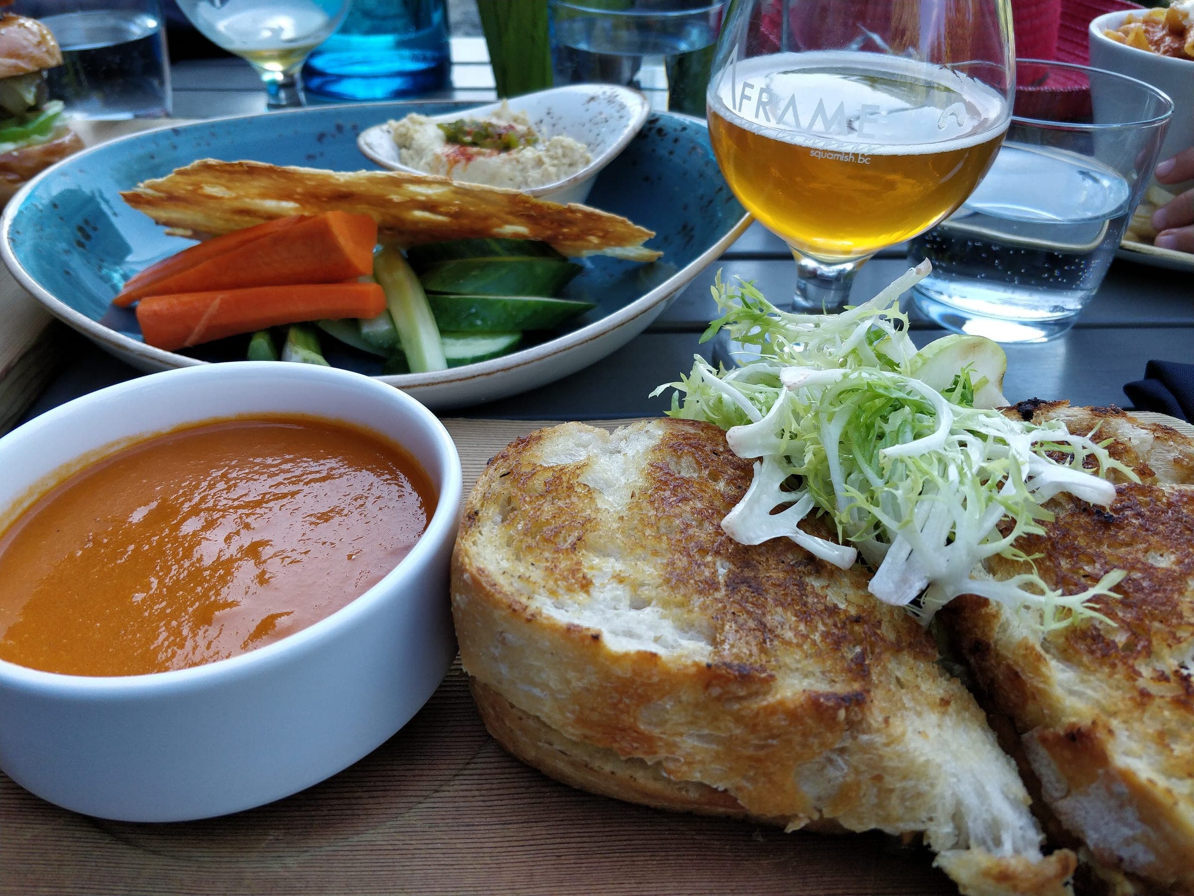 Grilled cheese, tomato soup and a local beer on the patio table at Nita Lake Lodge in Whistler.