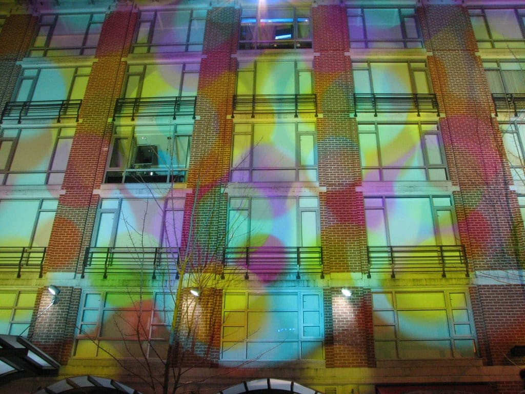 Coloured light patterns cover the windows on the Opus Hotel facade in Yaletown.