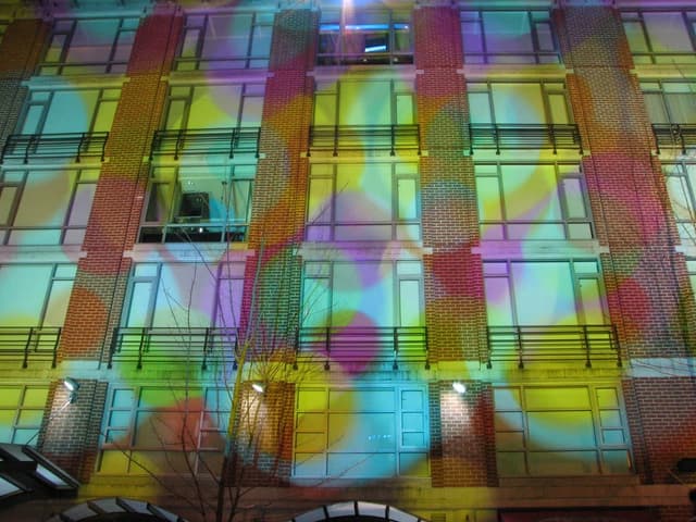 Coloured light patterns cover the windows on the Opus Hotel facade in Yaletown.