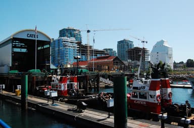 Red Cates tugboats tie up at the Lower Lonsdale docks below new towers and the old Shipyards buildings. (Lower Lonsdale)