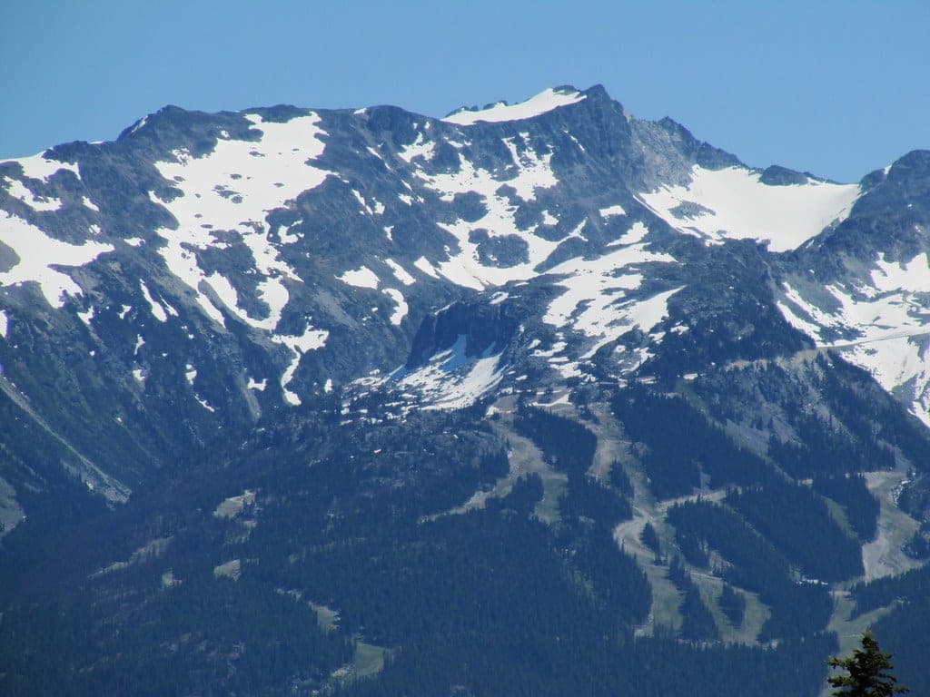 Snow patches streak Whistler Mountain's upper bowls in the view east from the Rainbow Lake trail.