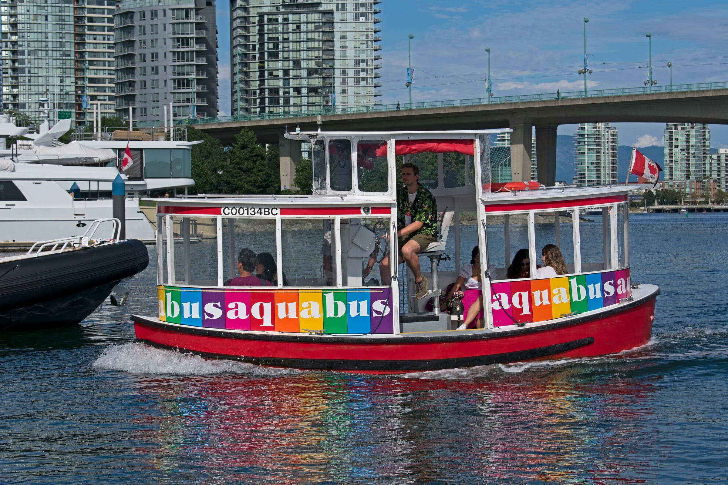 A red and white Aquabus ferry leaves the Yaletown dock in Vancouver.