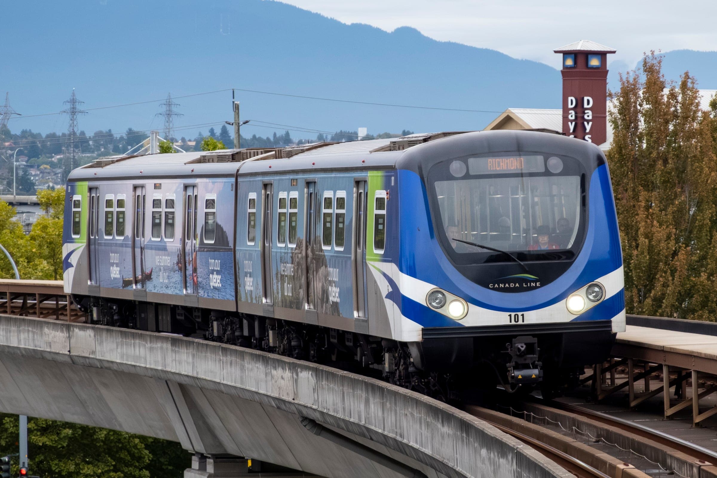 A Canada Line train rounds the elevated track into Capstan Station in Richmond.